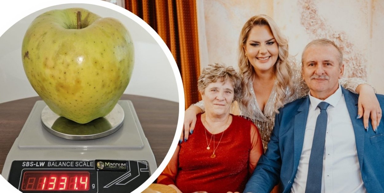 Mieczysław Socha z rodziną i jego wyjątkowo dorodne jabłko.